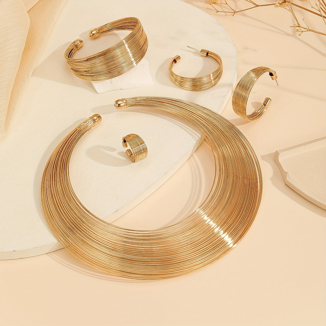 Choose between a luxurious jewelry set of necklace, bangle, earrings, and ring dupes, all plated in 18k gold with a multi-layer design in either silvery or golden. Make your decision now.