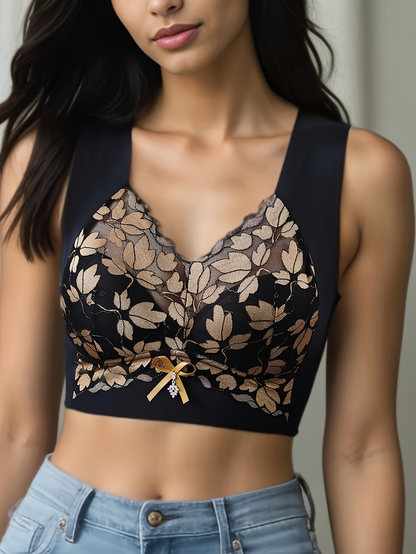 Polyamide and elastane bra with medium support, non-removable padding, plant pattern, contrast lace detail, wireless, scoop neck, and u-back design for spring/summer.