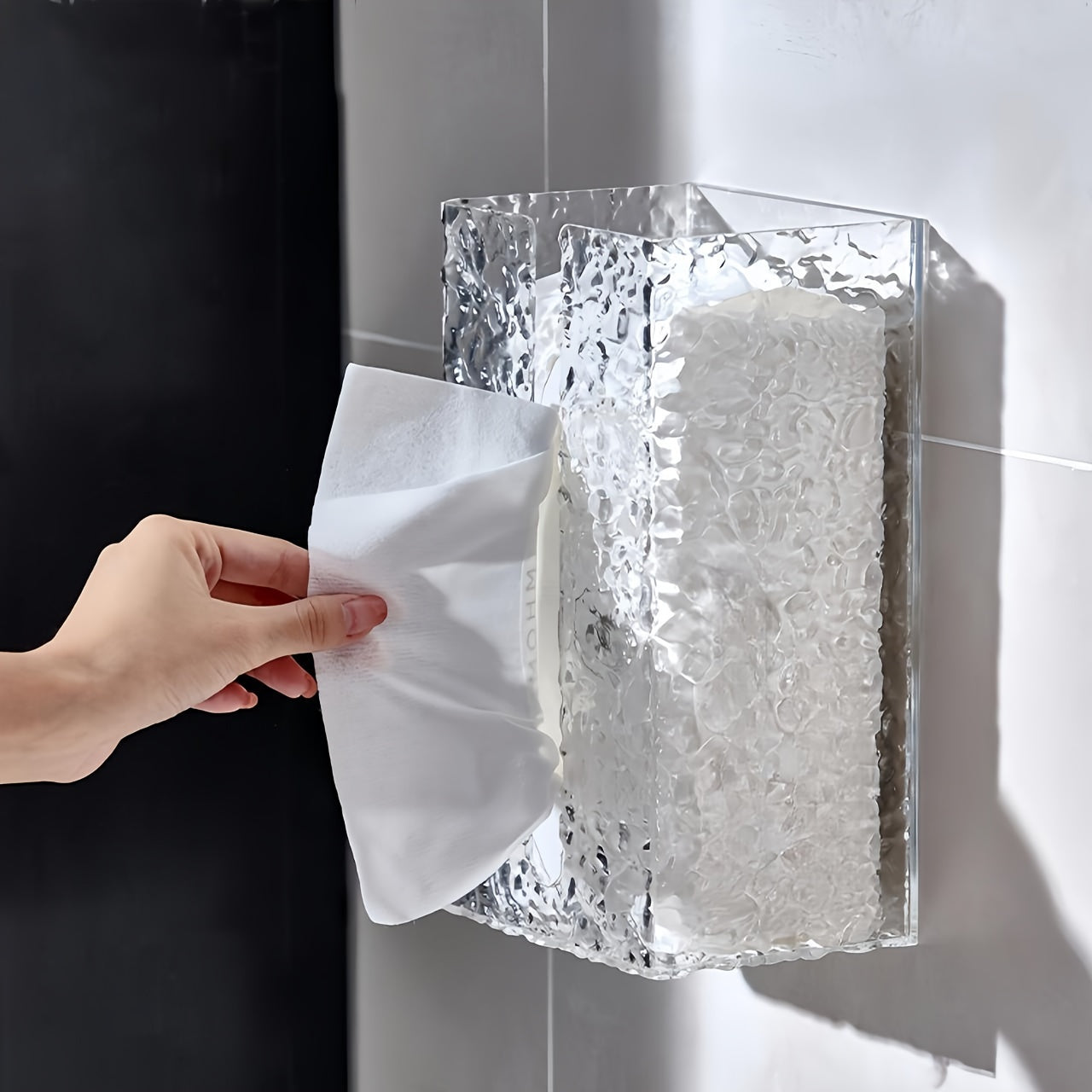 Simple wall-mounted tissue holder with wave texture, no-drill design for easy installation in kitchens and bathrooms, ideal for both home and hotel use.