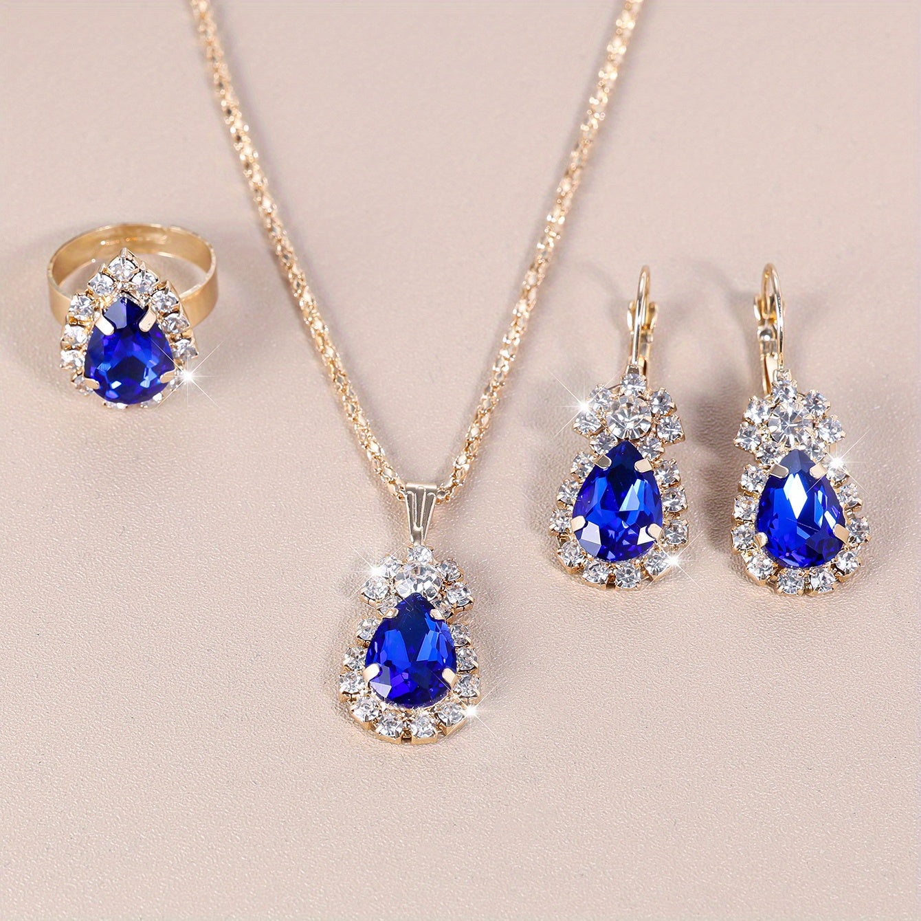 Complete your look with this elegant jewelry set featuring 4 pieces - earrings, necklace, and ring. Made with 18k gold plating and inlaid with shimmering zirconia in multiple colors to suit your style. Perfect for daily wear or adding a touch of glamour