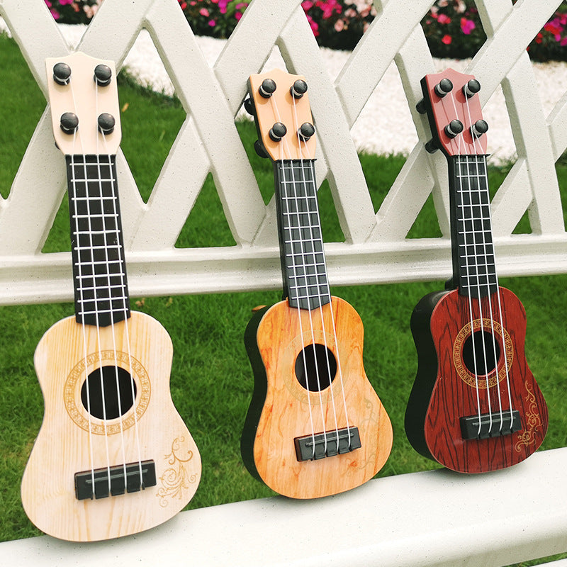 Mini playable uke instrument figurine made of plastic for home and office decor, ideal gift for music enthusiasts.