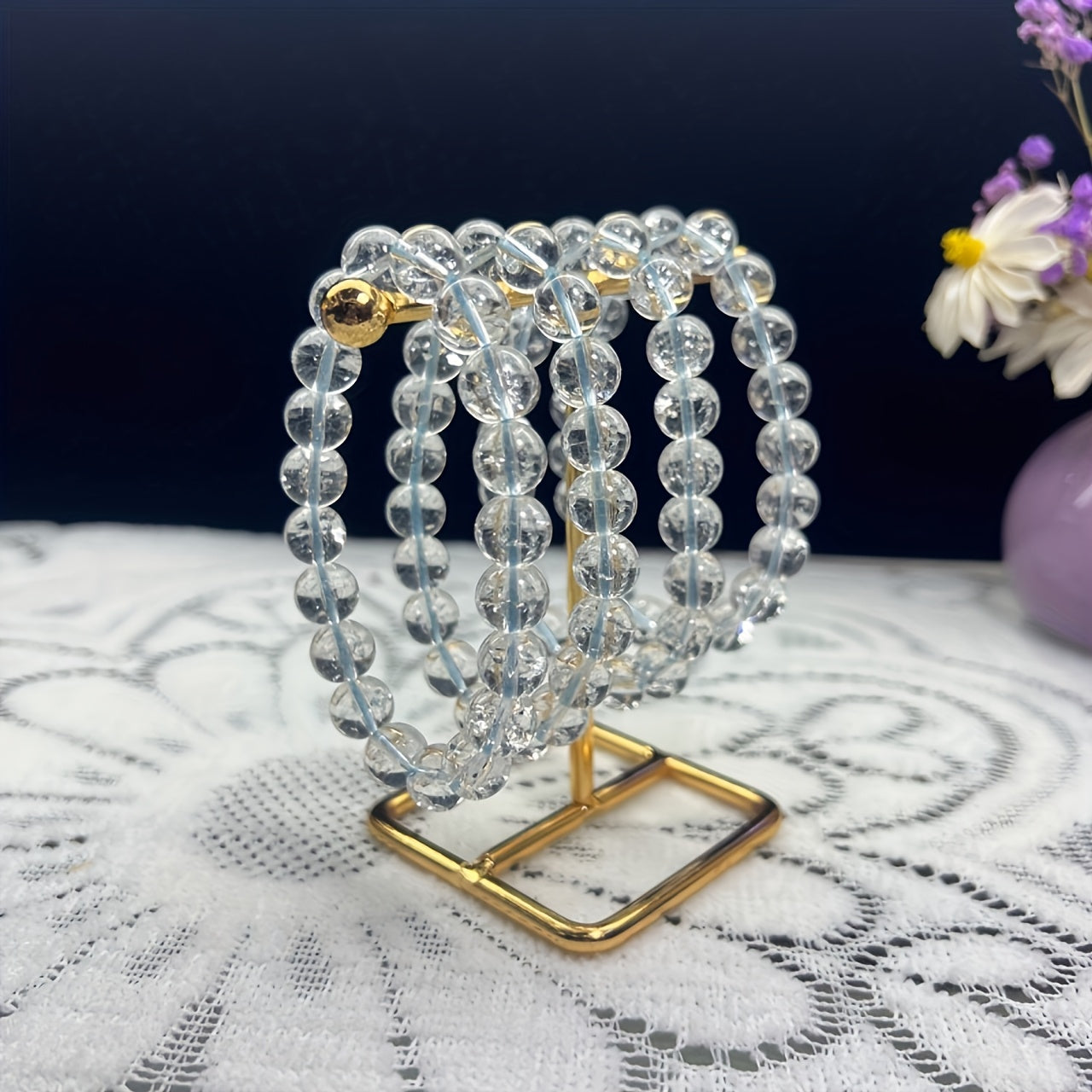 A stylish bracelet made from a single artificial white crystal round bead. The crystal is clear, shiny, and smooth, giving it a delicate and luxurious appearance. This bracelet exudes a fashionable, simple, and elegant style.