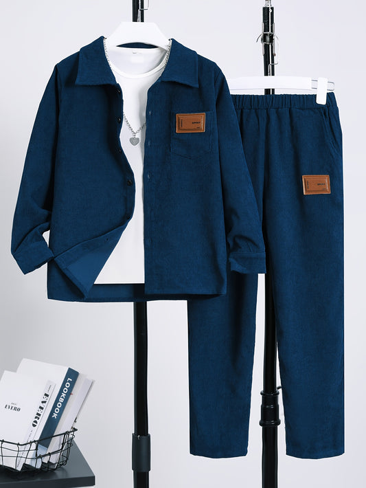 Two-piece set featuring solid navy blue corduroy shirt with button-down collar and pocket, paired with straight-leg pants with elastic waistband and pockets. Non-stretch, loose fit