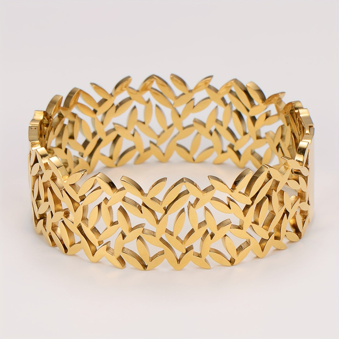 A stylish stainless steel bangle for women, featuring a delicate two-tone design with an irregular hollowed-out leaf bird's nest pattern. This fashionable botanical accessory is perfect for adding a touch of elegance to any outfit and makes a great gift