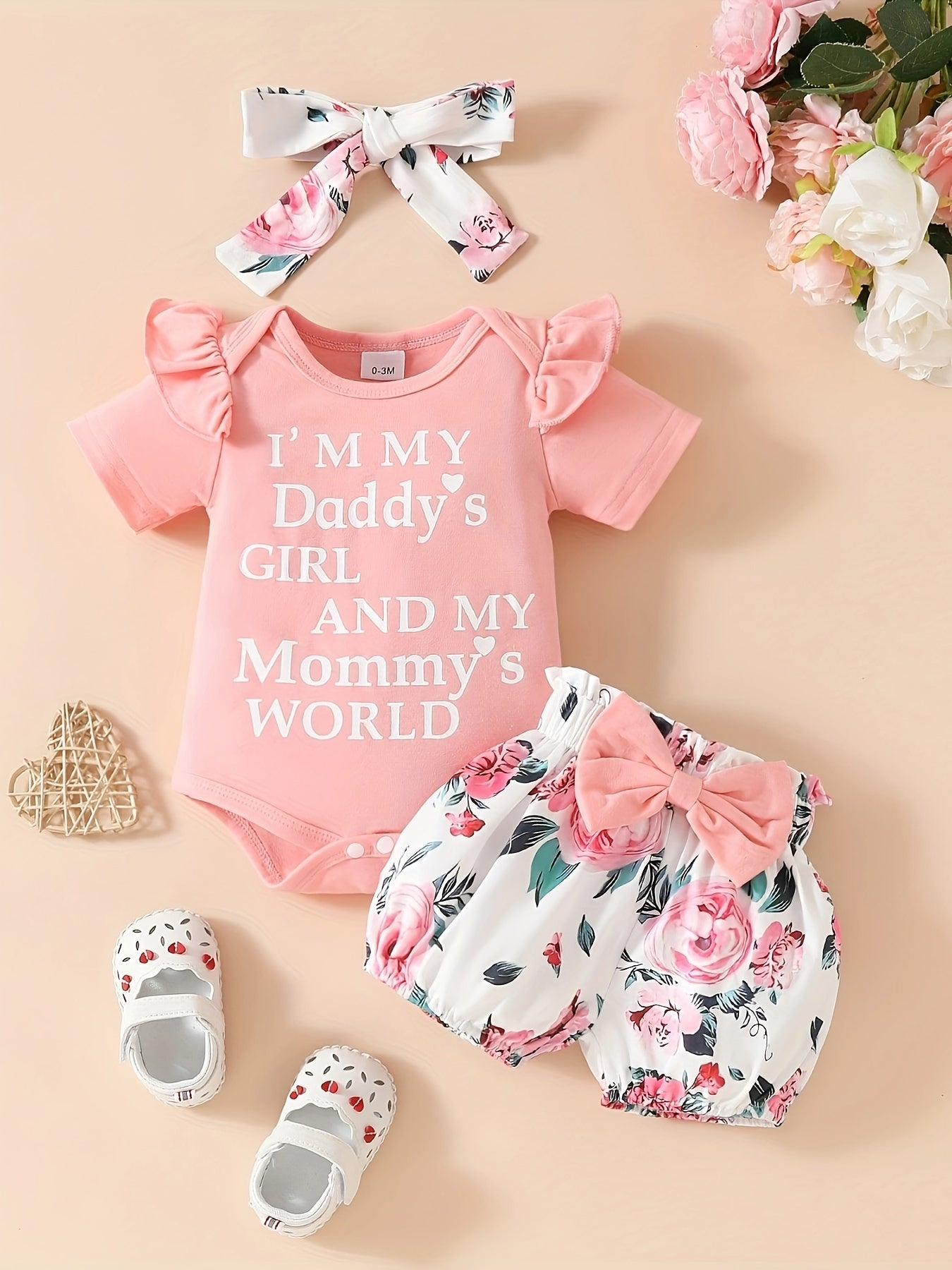 Cute 3-piece girls' outfit set with 'Daddy's Girl, Mommy's World' letter print romper, floral shorts, and matching headband. Made of soft polyester blend, ideal for summer and outdoor wear.