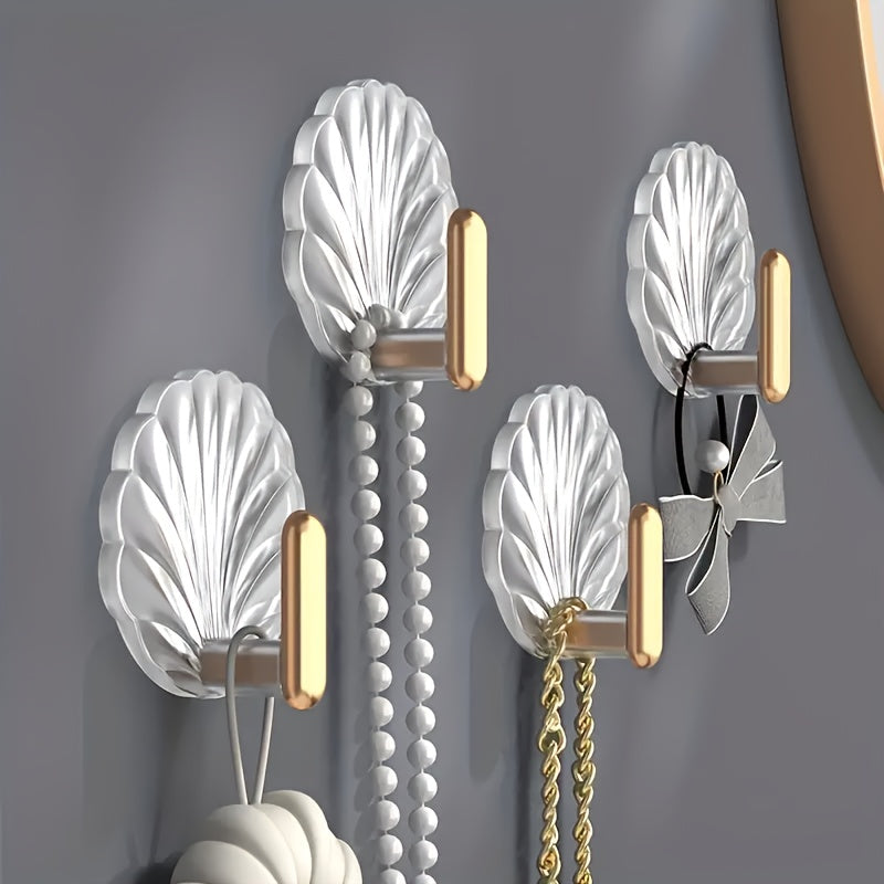 4 elegant waterproof adhesive hooks with golden accents for hanging items in kitchen, bathroom, or bedroom.