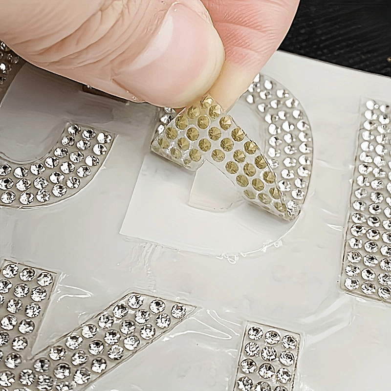 26 pieces of self-adhesive silvery rhinestone letters from A to Z, backed with iron and made of glass. Perfect for DIY projects on clothing, shoes, hats, car decorations, and other hobby crafting activities. Mix and match to personalize your items with a