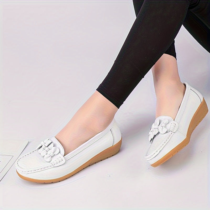 Women's flat shoes with bow detail, solid color, round toe, slip-on design for casual walking.