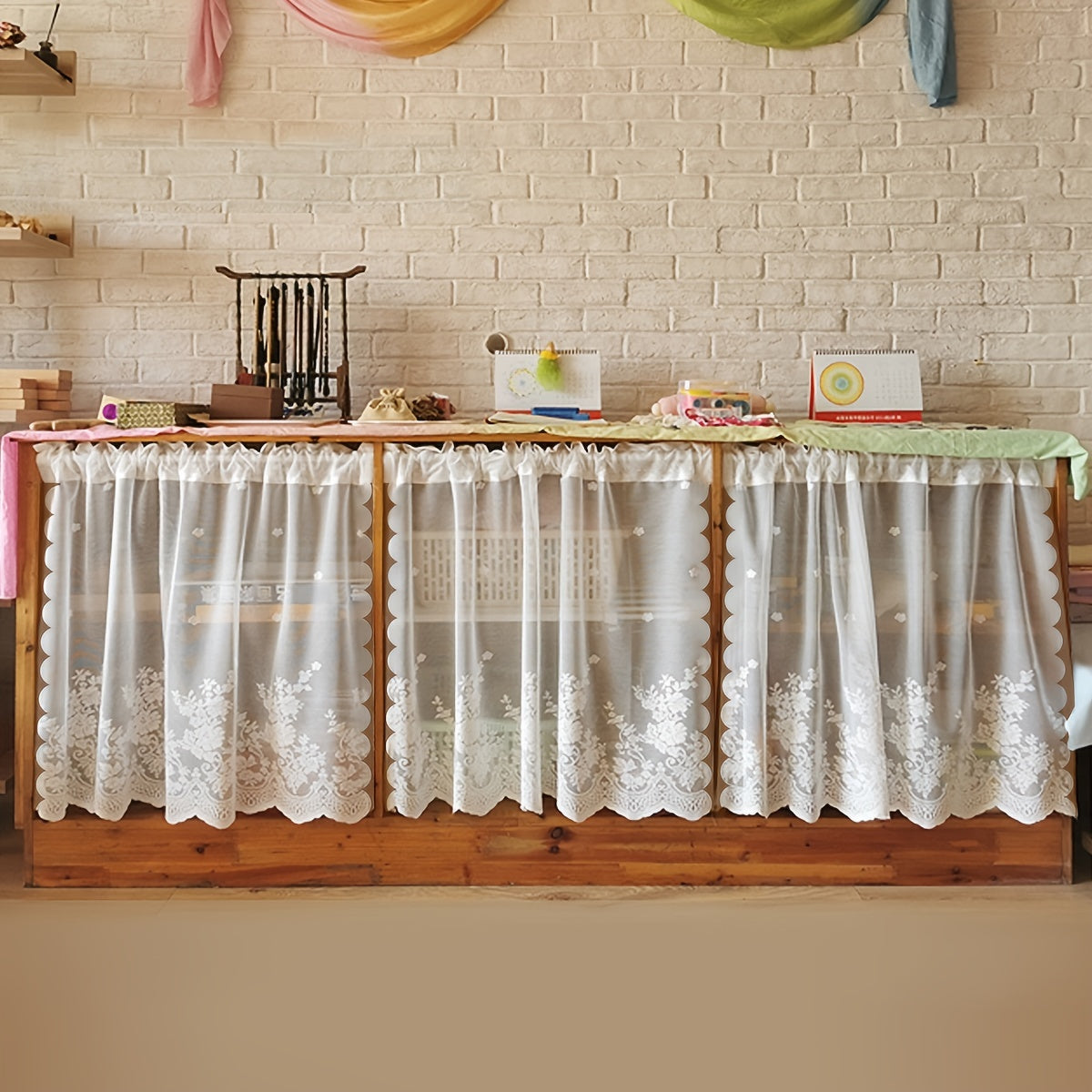 Elevate your space with this elegant black floral lace cafe curtain. Featuring a sweet and simple design, this curtain is made of sheer polyester and has a rod pocket for easy installation. Perfect for adding a touch of sophistication to your kitchen