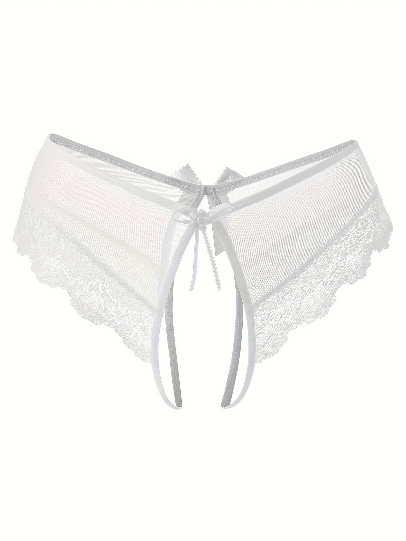 Transparent lace thong briefs with open crotch, low-rise design. Made of 90% polyamide and 10% elastane knit fabric, weighing 111 gsm.