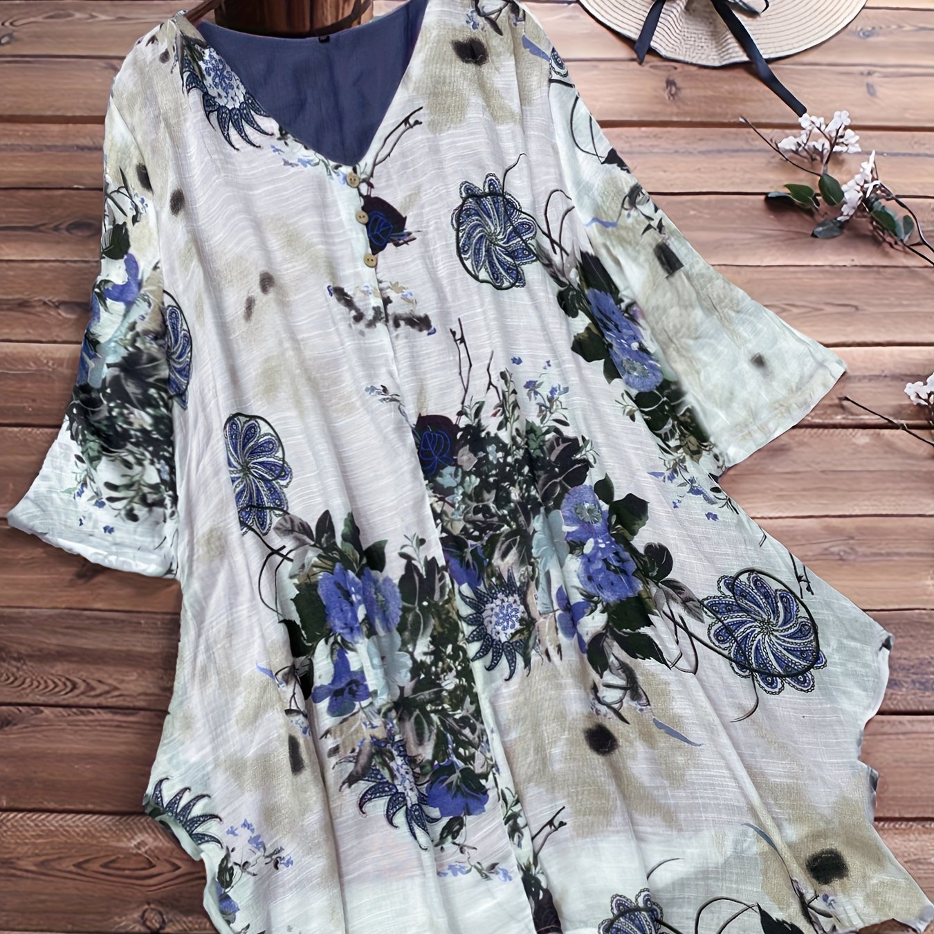 Women's plus size casual top with floral print, short sleeves, V-neck, and asymmetrical hem.