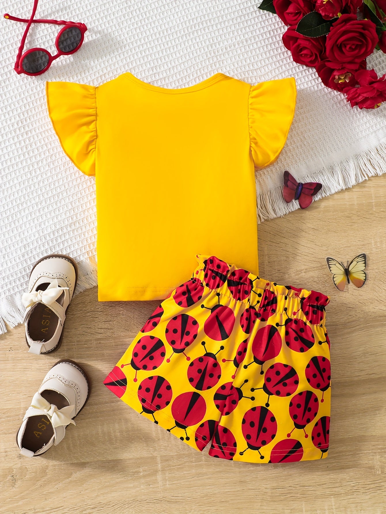 Ruffle sleeve graphic tee and ladybug shorts set for baby girl, perfect casual summer outfit.