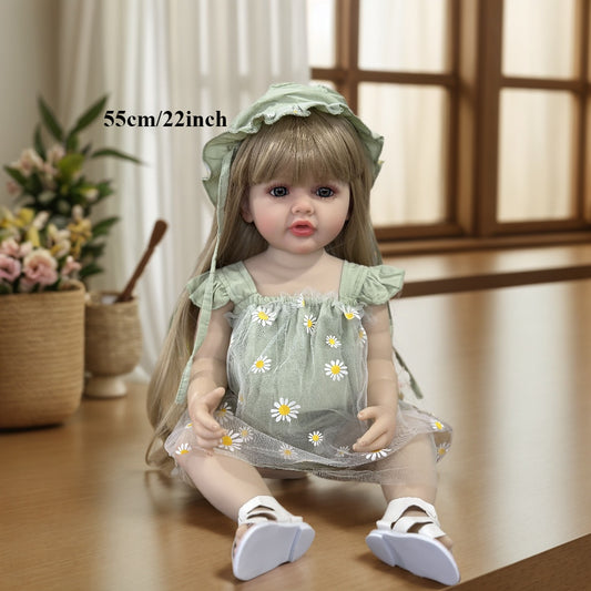 Realistic 55.88 cm full vinyl body reborn baby doll with long blond hair, dressed in a green dress with daisy pattern. Beautiful toddler doll toy for collectors.