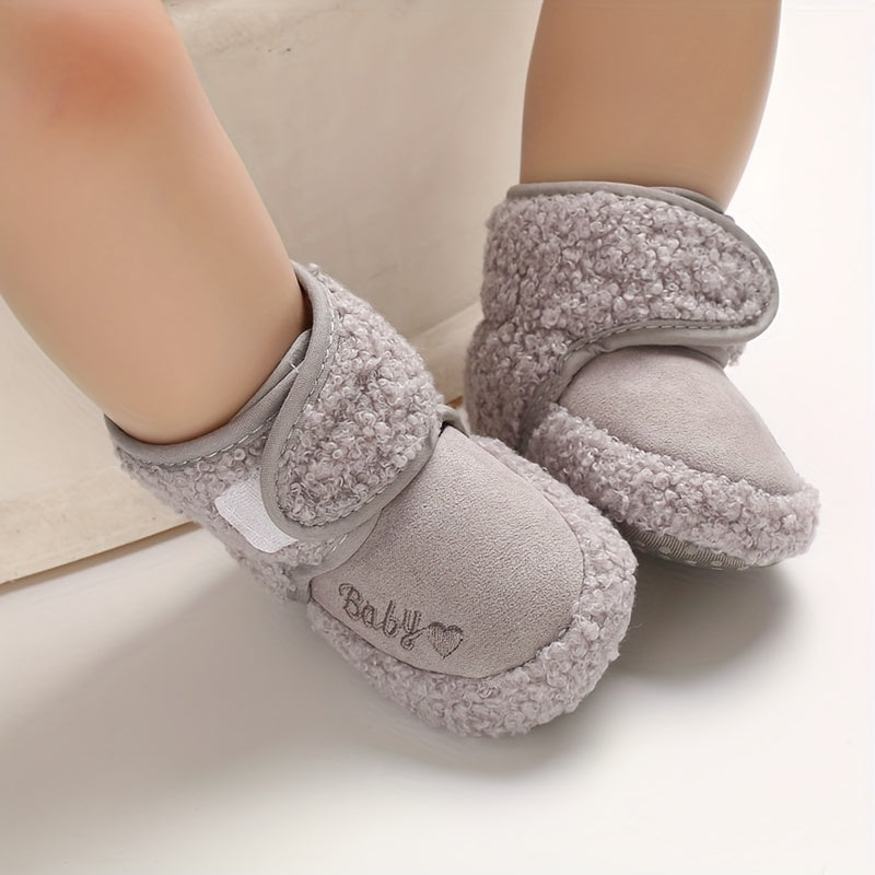 Cozy boots for baby boys and girls, featuring hook and loop fasteners for indoor and outdoor winter walks.