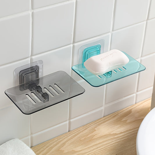 Wall-mounted soap dish with drainage, adhesive holder for bathroom organization.