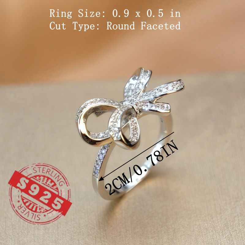 Chic 925 Sterling Silver Ribbon Bow Tie Ring featuring Natural Zirconia, perfect for July Birthdays. This Tribal & Cute style ring is 925 Silver Plated, Tarnish-Resistant, and adorned with Heart-Themed details. Ideal for Daily Wear or Wedding occasions