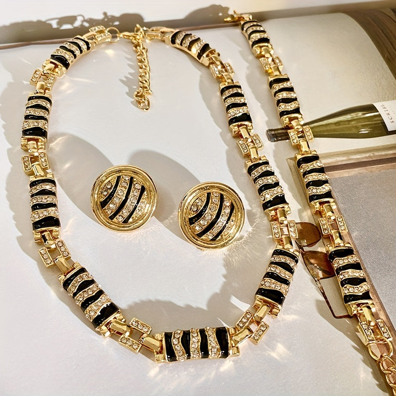 Chic and Stylish French-Inspired Zebra Print Jewelry Set - Featuring Vintage Geometric Design in Gold Plated Enamel with Sparkling Rhinestone Details. Complete with Necklace, Bracelet, and Earrings; Ideal for Everyday Wear, Events, and Celebrations.