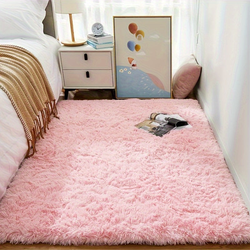 Soft and fluffy pink area rug, machine washable with a shaggy design. Perfect for adding a cozy touch to any living room, nursery, or dorm room. Non-slip and aesthetically pleasing.