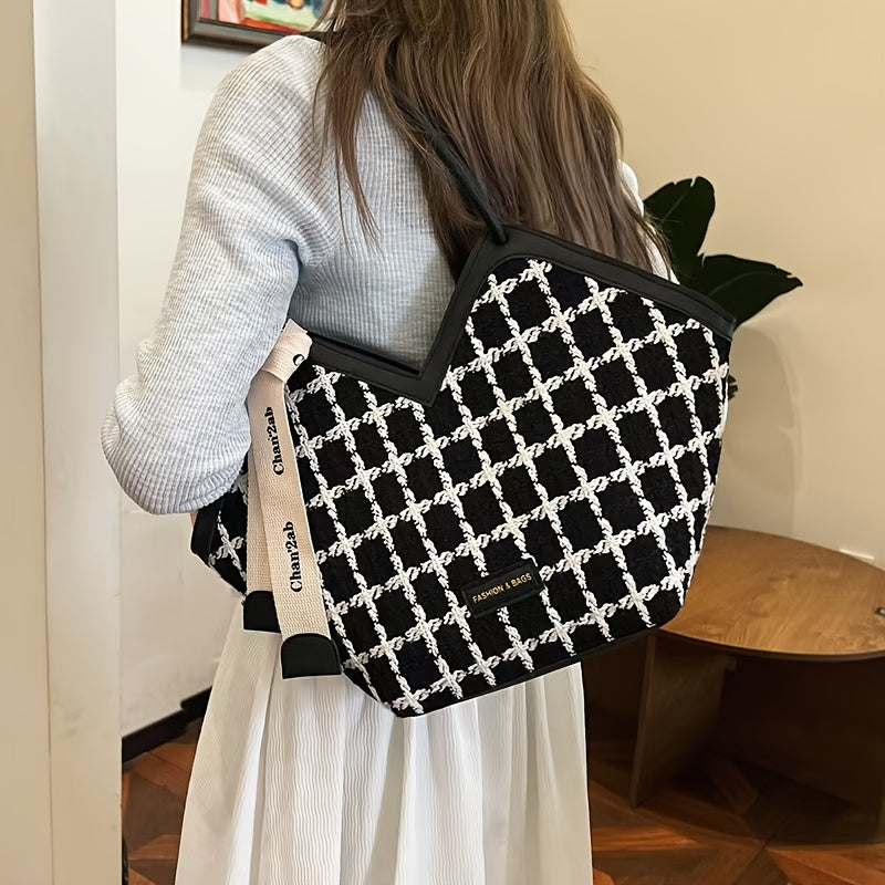 Stylish black plaid tote bag for women, spacious with zip closure and matching strap.