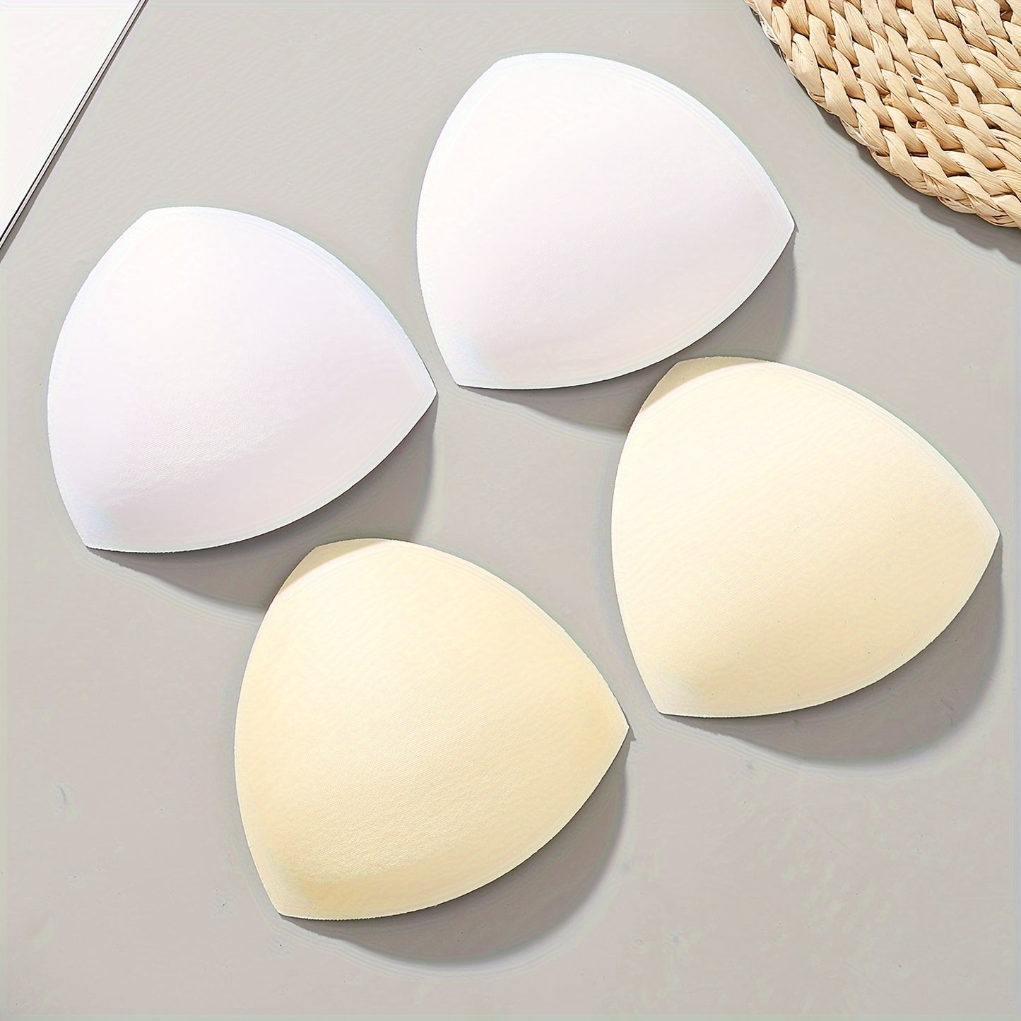 Women's triangle bra pads enhance and lift with push-up and adjustable features. Available in black, white, and nude colors.