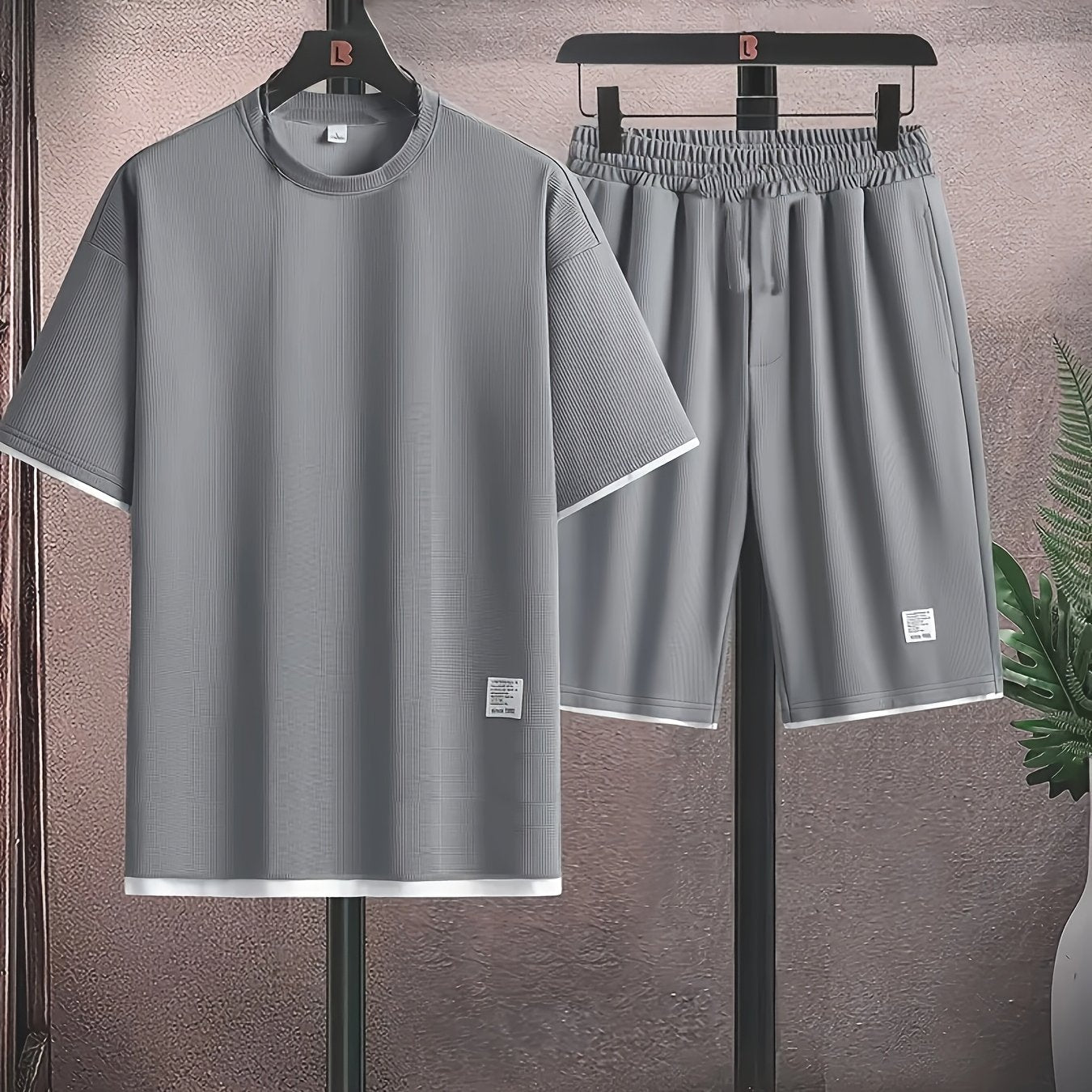 Men's casual waffle knit pajama set in gray and black with short sleeve top and elastic waist shorts. Features applique detailing and soft polyester fabric for comfort.