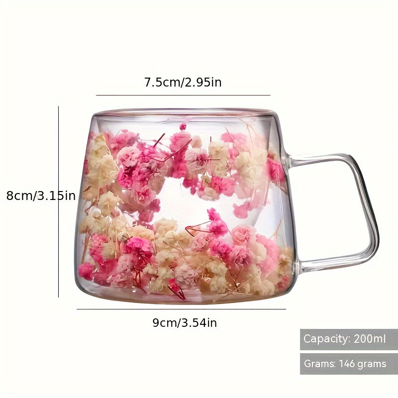 Elegant floral glass coffee mug with real dried flowers, double-walled insulated design in pink and clear. Hand wash only, BPA-free. Perfect for tea or coffee at home.