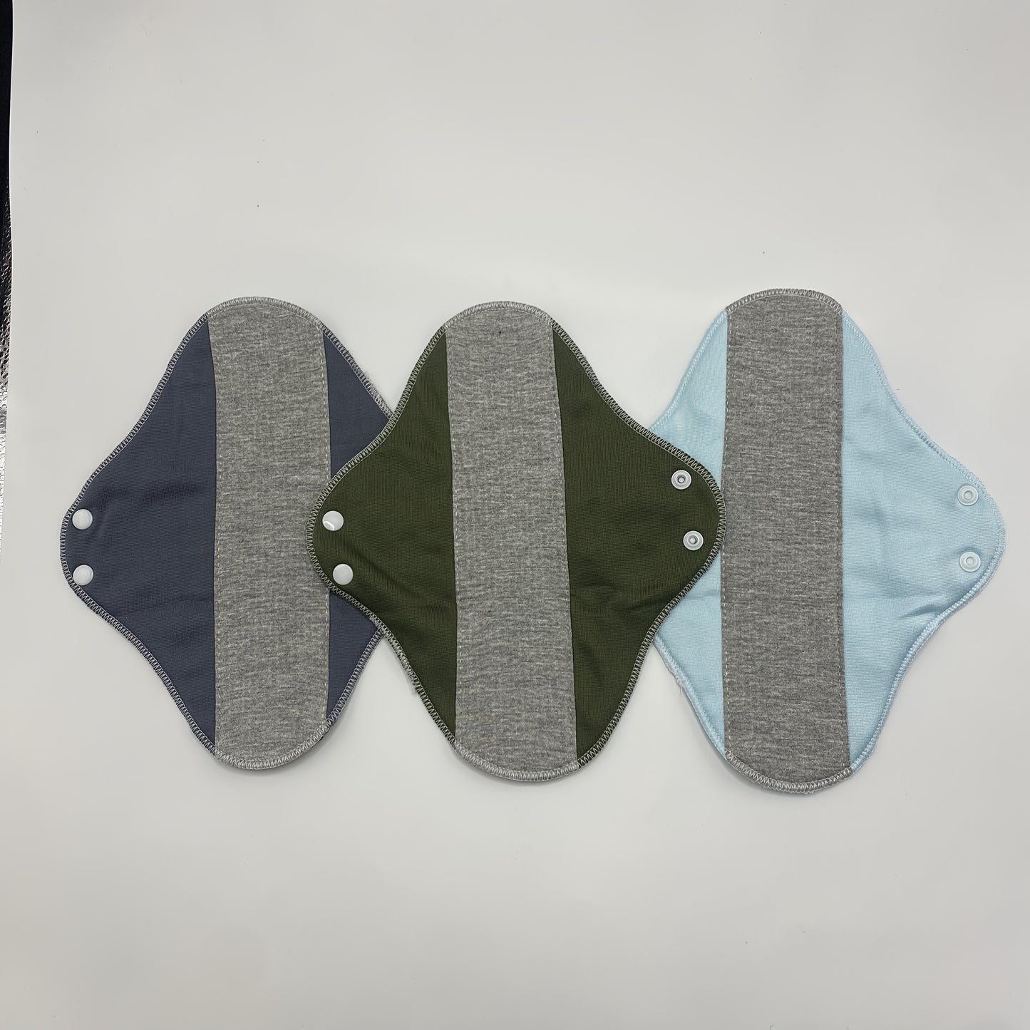 4-Pack reusable menstrual pads featuring soft graphene fabric for leak-proof washable period protection. Solid color design with non-woven fabric for added comfort.