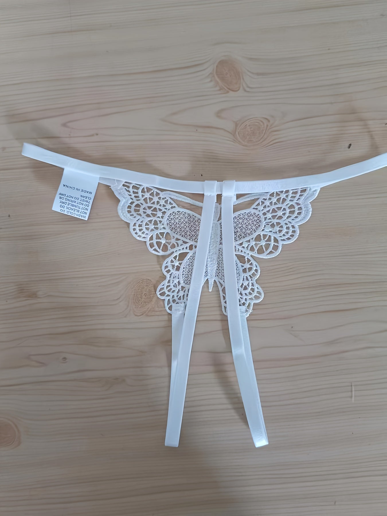 Sexy butterfly pattern panties with open crotch and low waist for women.