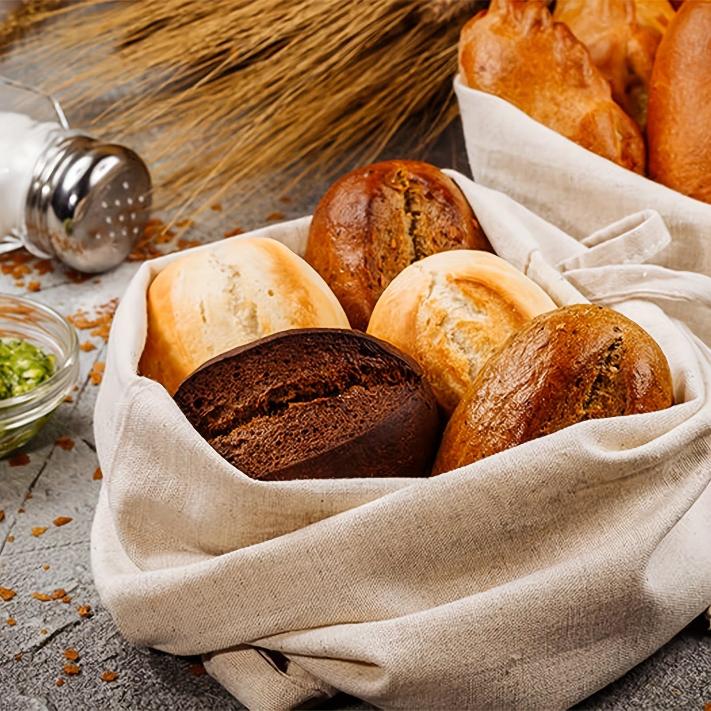 Set of three linen bread bags designed for storing homemade and artisan bread. These reusable fabric containers are unbleached and feature a drawstring closure for safe food contact.