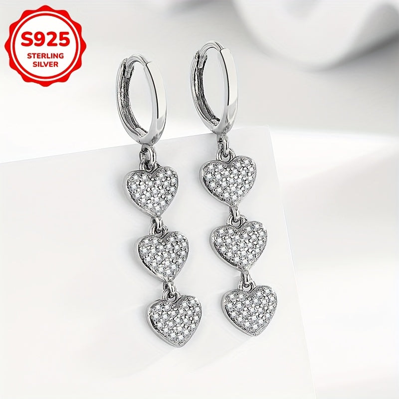 These exquisite ladies' earrings feature dazzling heart-shaped pendants embellished with synthetic zirconia, set in 925 silver. Weighing 3.6g, they are perfect for both daily wear and special occasions such as banquets.