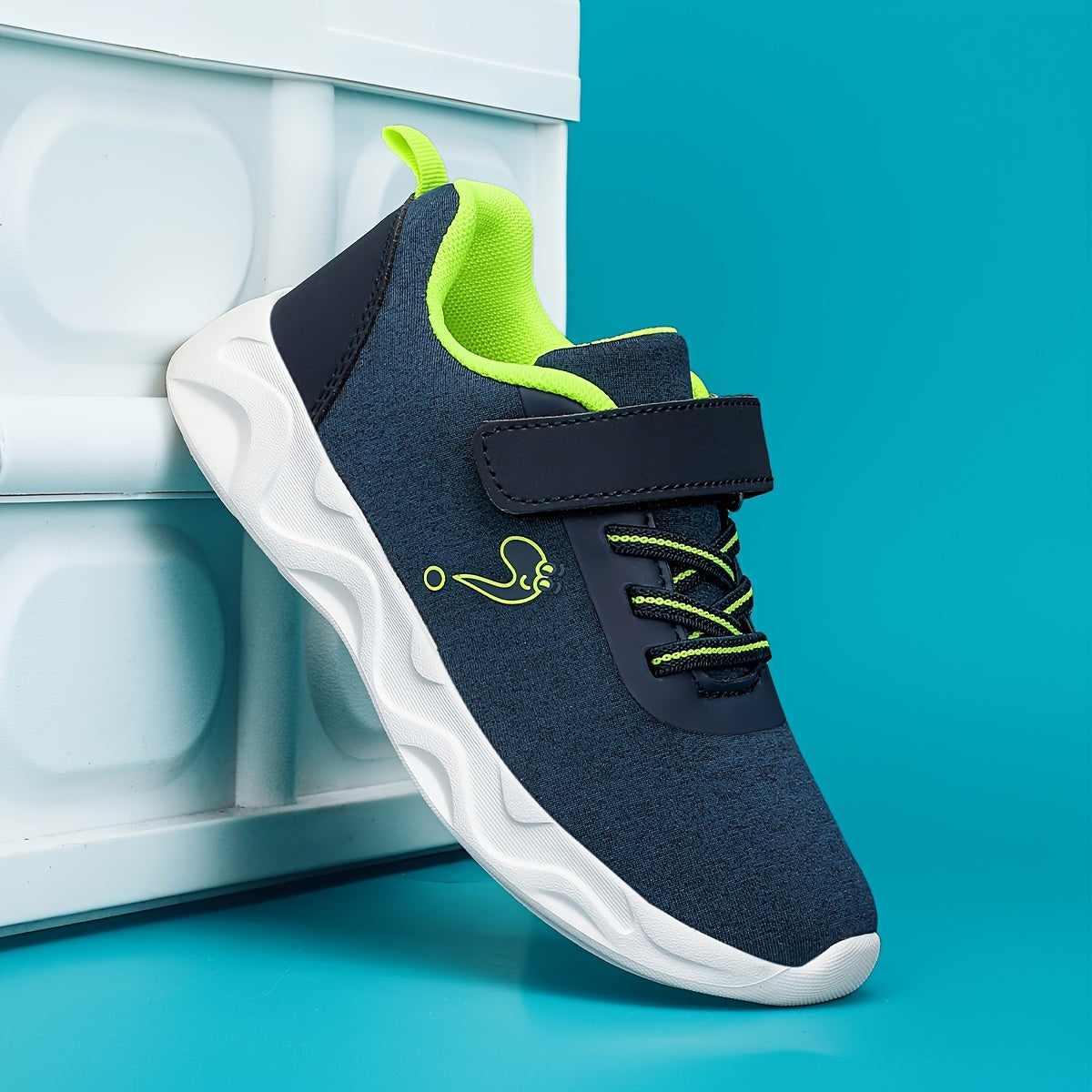 Breathable sneakers for kids with non-slip soles and hook and loop closure.