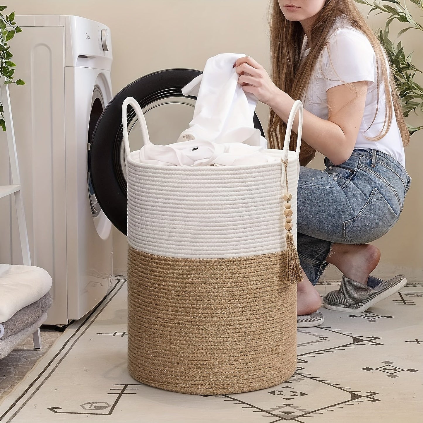 This tall laundry basket measures 40.64cm X 50.8cm and features a woven design with a convenient handle. It can be used as a blanket organizer in the living room, a storage basket for dog toys, or a decorative jute laundry hamper for clothes, pillows