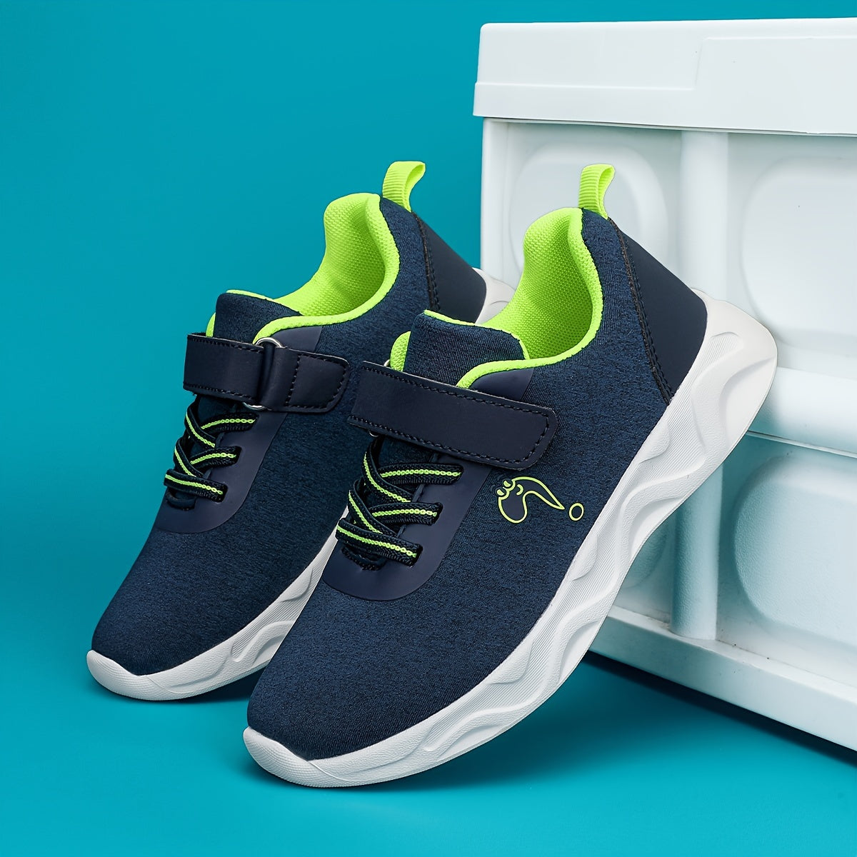 Breathable sneakers for kids with non-slip soles and hook and loop closure.