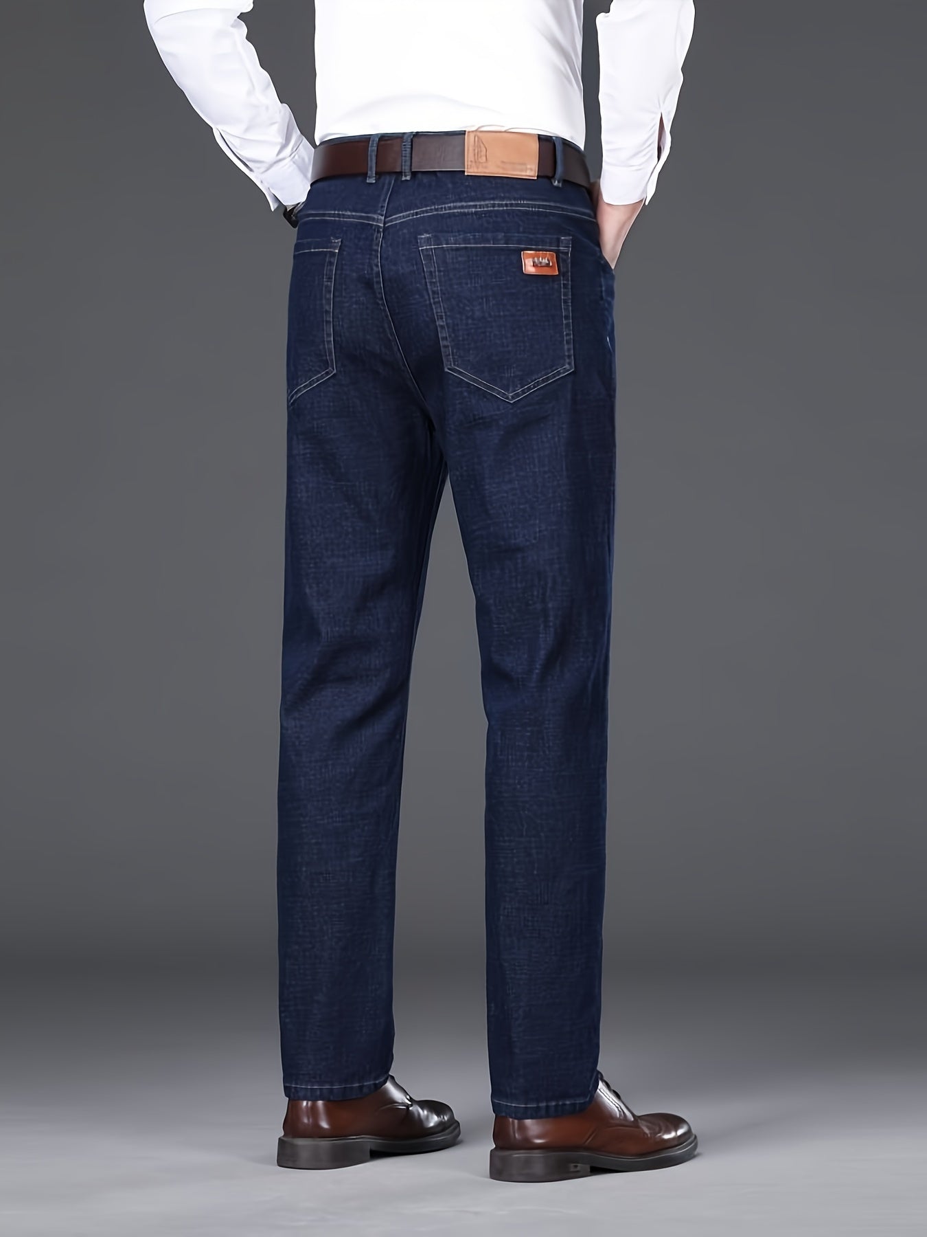 Men's dark blue jeans with patch, straight leg fit, ribbed cuffs, and durable cotton blend denim. Machine washable, comfortable, and smooth fabric.