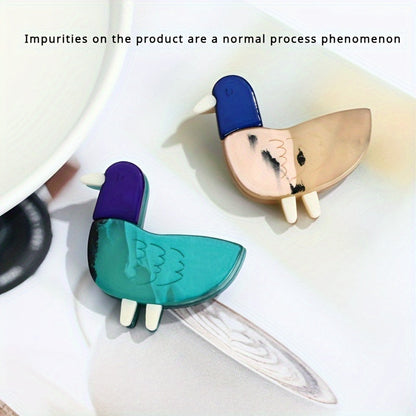 Animal-shaped acrylic duckling brooch pin with color block design is a cute fashion accessory for collars and clothing.