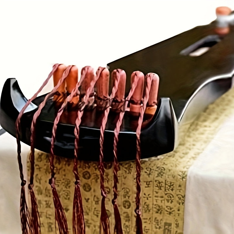 NUNUGGS Traditional Chinese Guqin made of solid paulownia wood with elegant black finish and golden tone tuning pins. Suitable for beginners, photo props, and antique interpretation.