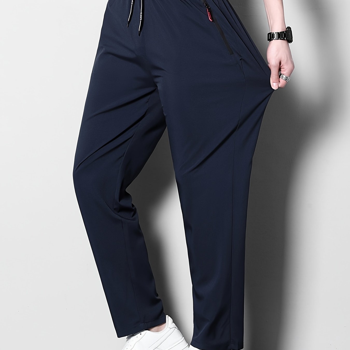 Men's plus size casual sports pants, made of stretchy polyester in a solid color with a regular fit, zipper detail, part of the spring/summer collection.