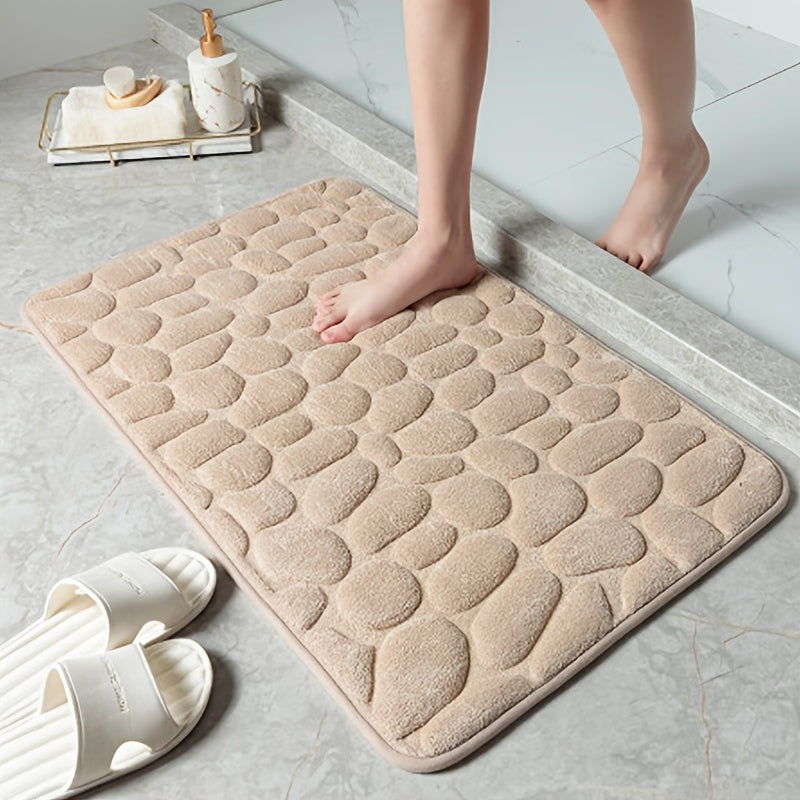 Soft and luxurious memory foam bath mat with a non-slip pebble design. This water-absorbent bathroom rug is machine washable and made of flat woven polyester with PVC backing. Featuring a low pile and solid pattern, it has non-slip capabilities for added