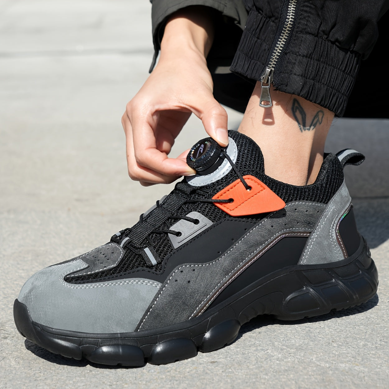 Steel toe work shoes with breathable design, puncture-resistant sole, and durable fabric upper in gray/black/orange. Perfect for construction and industrial tasks.