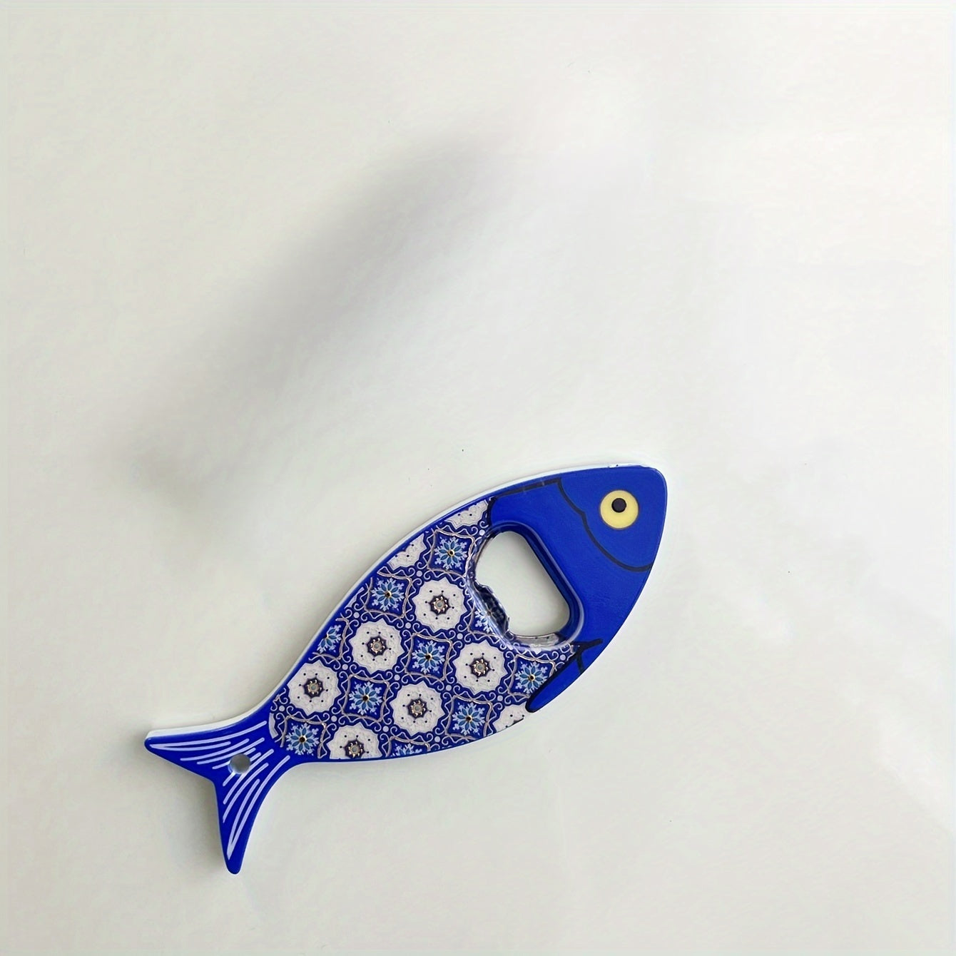 Fish-shaped cap opener with magnet for refrigerator decoration, no power required.