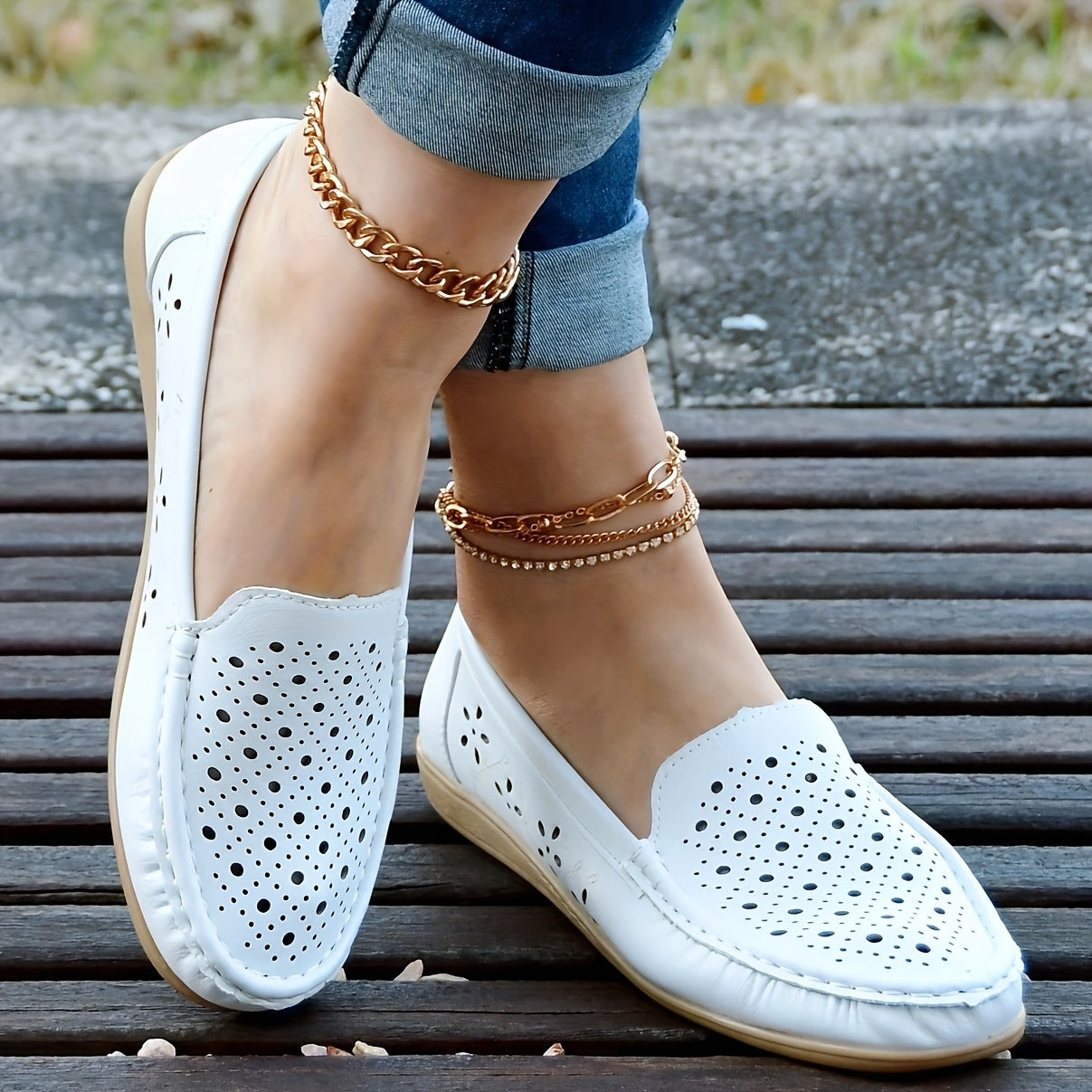 Women's white slip-on loafers with perforated design for breathability, non-slip sole, round toe, and versatile casual style for all-season wear.