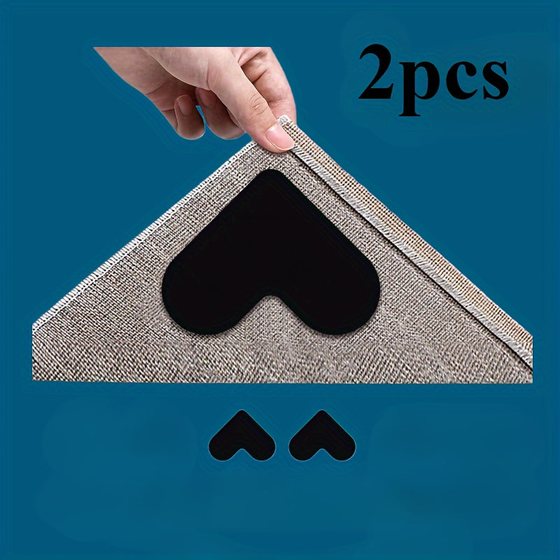 Two washable heart-shaped anti-slip rug grip tape pads, perfect for securing carpets on hardwood floors or tile. Leaves no residue and made from Polyvinyl Chloride PVC material, ideal for use in office, entryway, or bedroom.