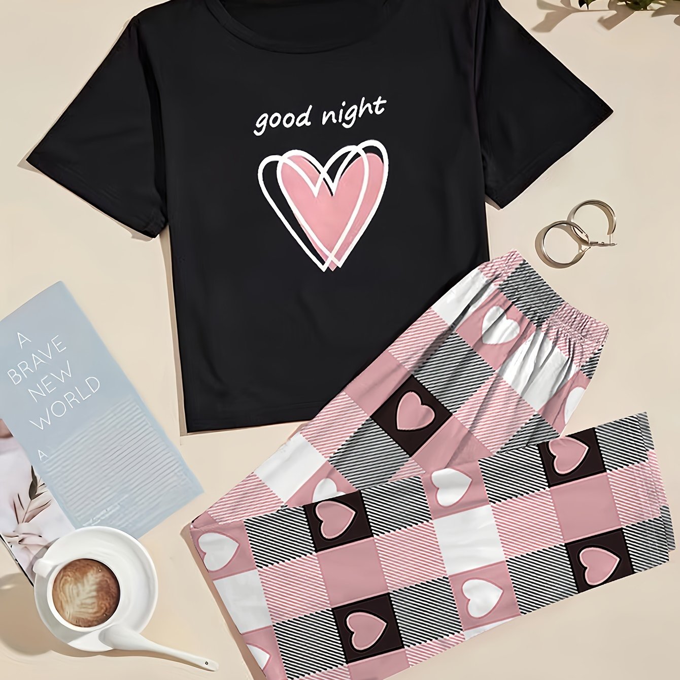 Women's heart graphic t-shirt and plaid pants set in casual polyester knit, featuring a short sleeve top with crew neck and elastic waist lounge pants. Perfect for lounging or sleepwear.