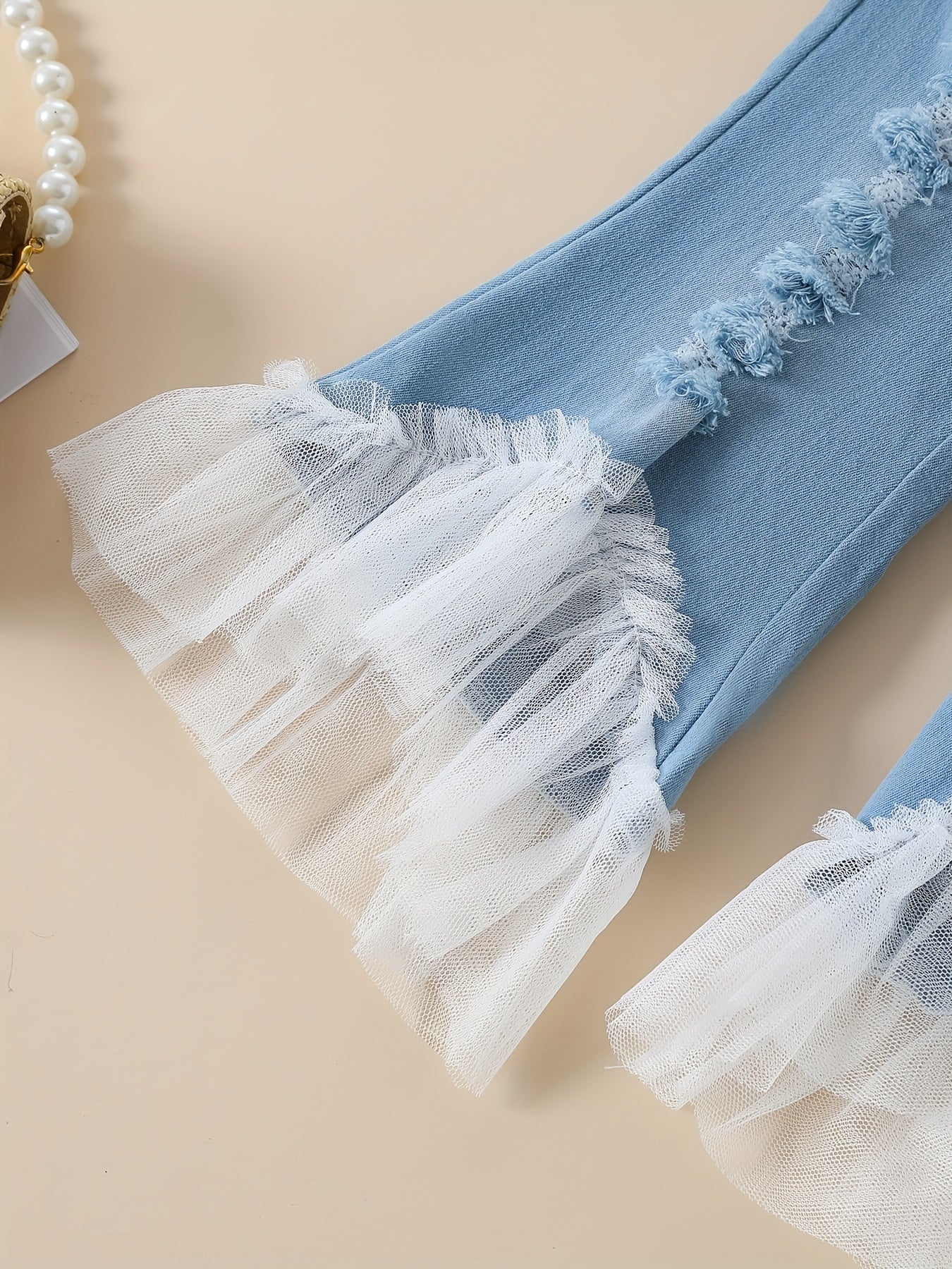 Stylish girls' summer outfit: off-shoulder white lace top with blue tulle flared pants set. Made of 100% polyester, machine washable. Perfect for outdoor wear.