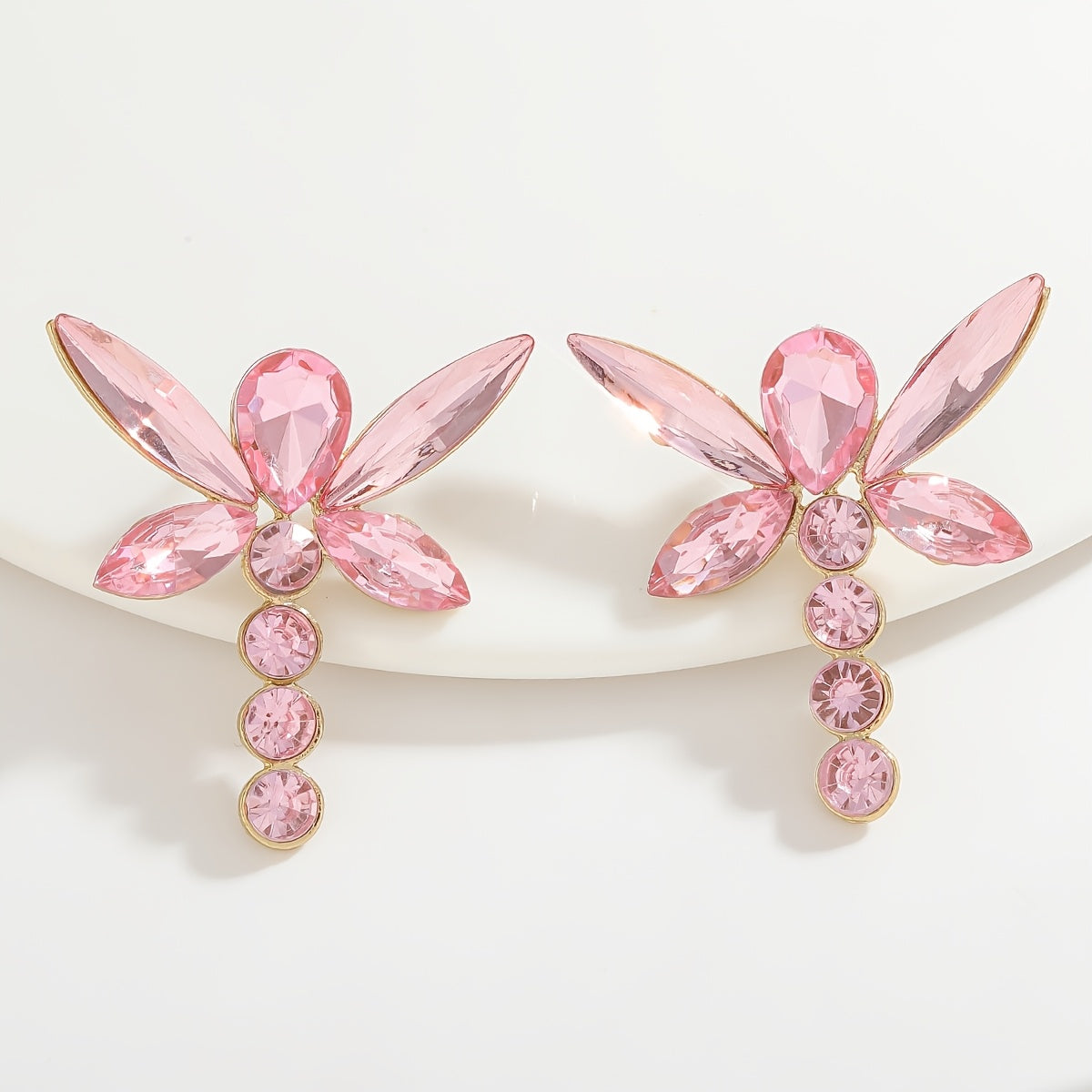 Add a touch of sparkle this Valentine's Day with our Pink Heart & Crystal Winged Drop Earrings. Featuring an elegant bling style, these earrings are made of Zinc Alloy with Stainless Steel Posts, perfect for weddings, parties, and gifts. The Round