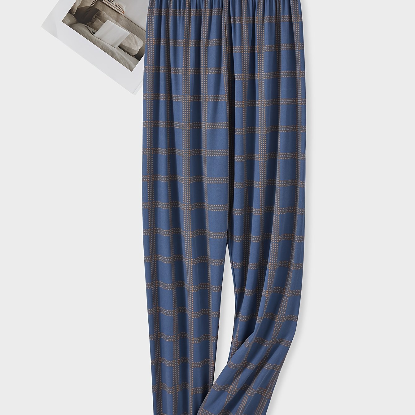 Men's plaid pajama pants in blue and brown, cozy polyester with elastic waistband. Suitable for spring/fall, comfortable and machine washable. Features checkered pattern and knitted weave.