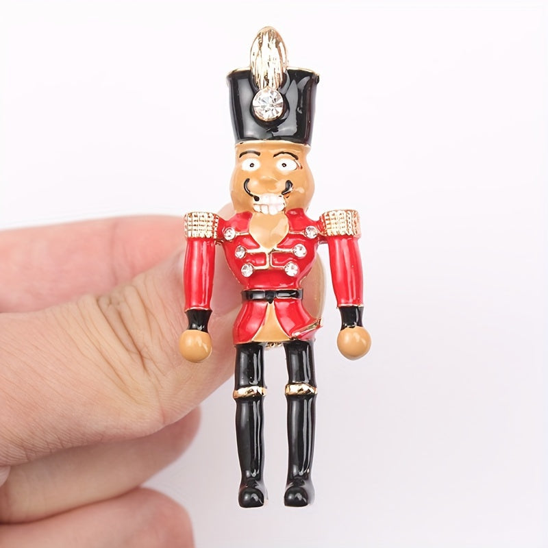 Holiday Nutcracker Soldier Brooch Pin, a festive accessory to adorn your lapel or clothing with a touch of whimsy. Perfect for adding a decorative flair to your outfit.