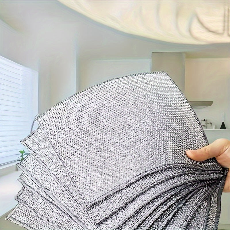 Kitchen scrubbing pads with a double-layer silvery edge are available in packs of 5 or 15. These scratch-resistant cloths can be used wet or dry for cleaning tableware, steel wire, and various surfaces such as bathroom doors and windows. The magic