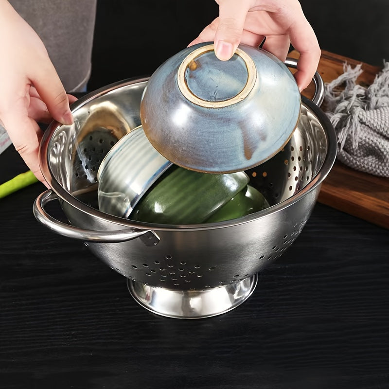 One piece of a durable metal colander with handles, perfect for washing and draining vegetables, fruits, and pasta. This food-safe kitchen strainer is made of stainless steel and comes with a sturdy base.