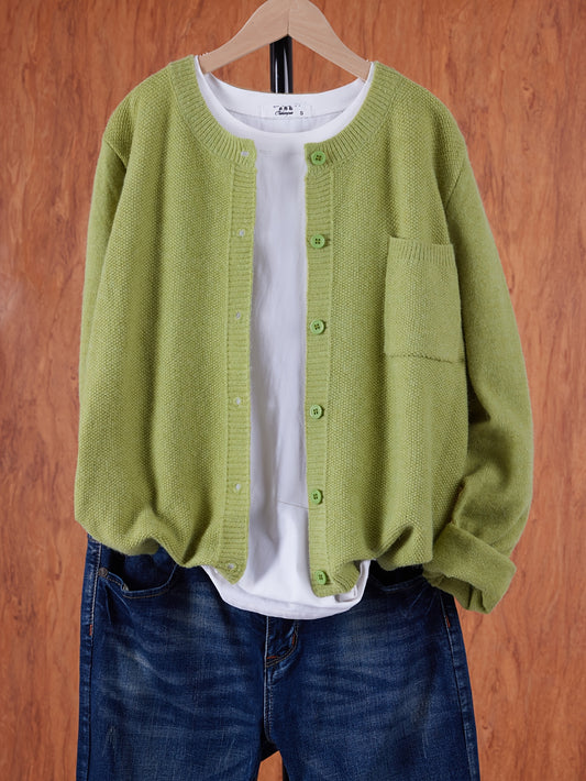 Solid cardigan with drop shoulders, button front, and patched pockets for women's casual spring and fall fashion.